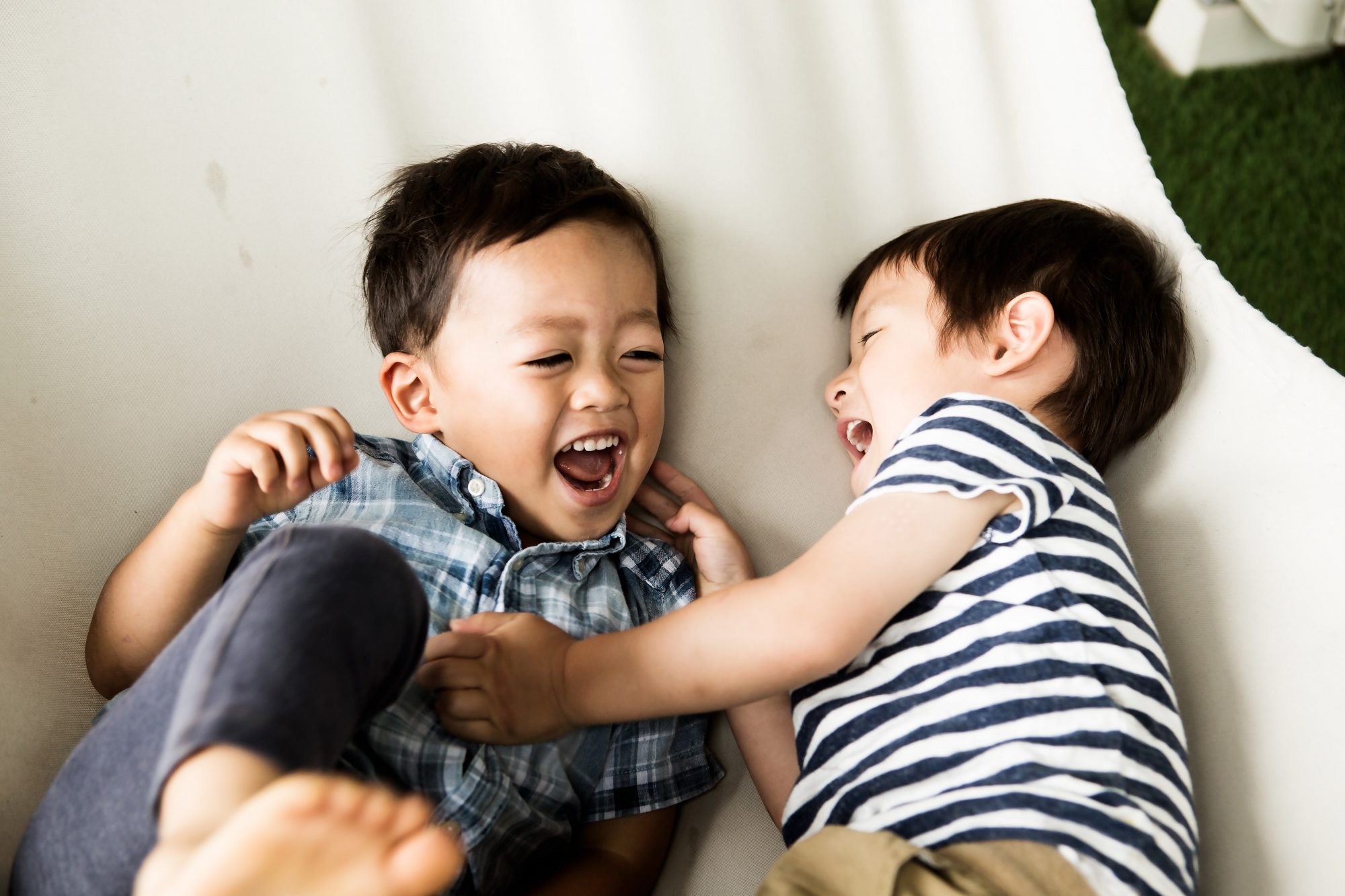An image of two boys laughing together.