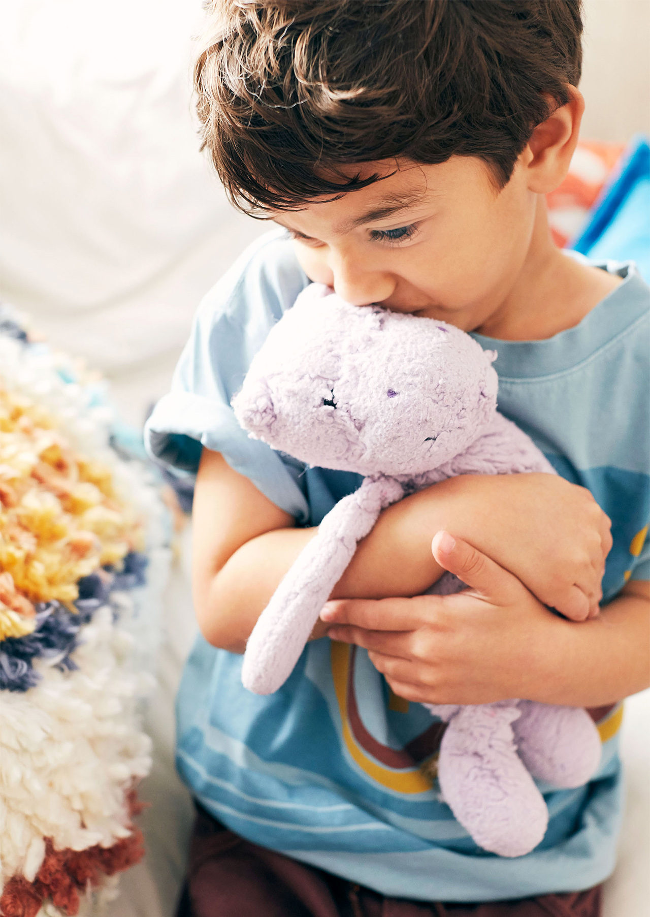 child holding stuffed animal