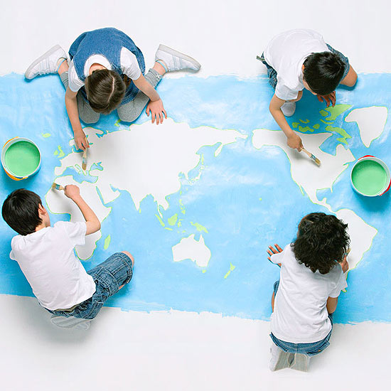 Kids painting map of world on floor